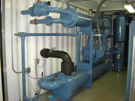 conteraized engine room with industrial blue pipes